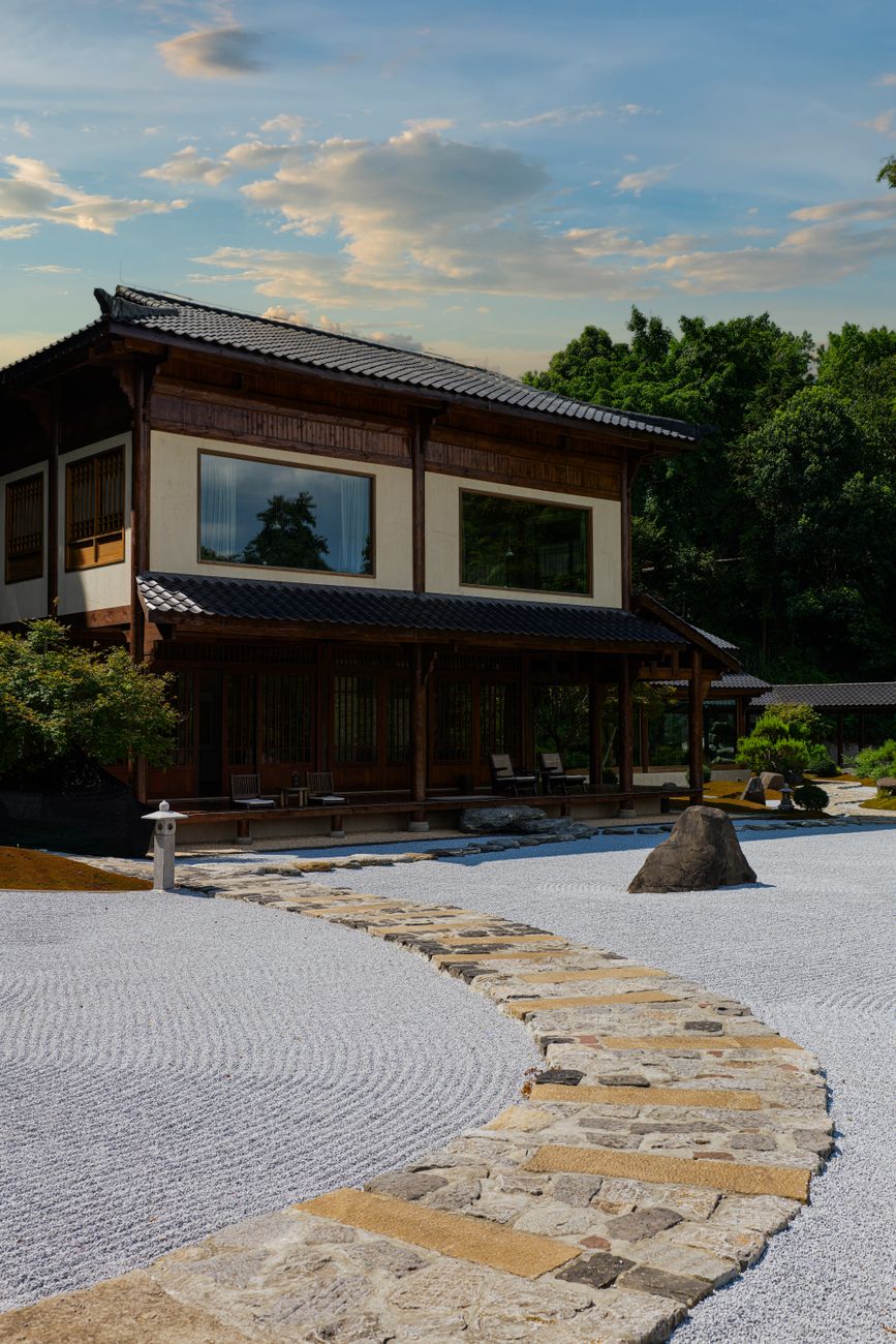 A serene stone path winding through a bamboo and moss garden