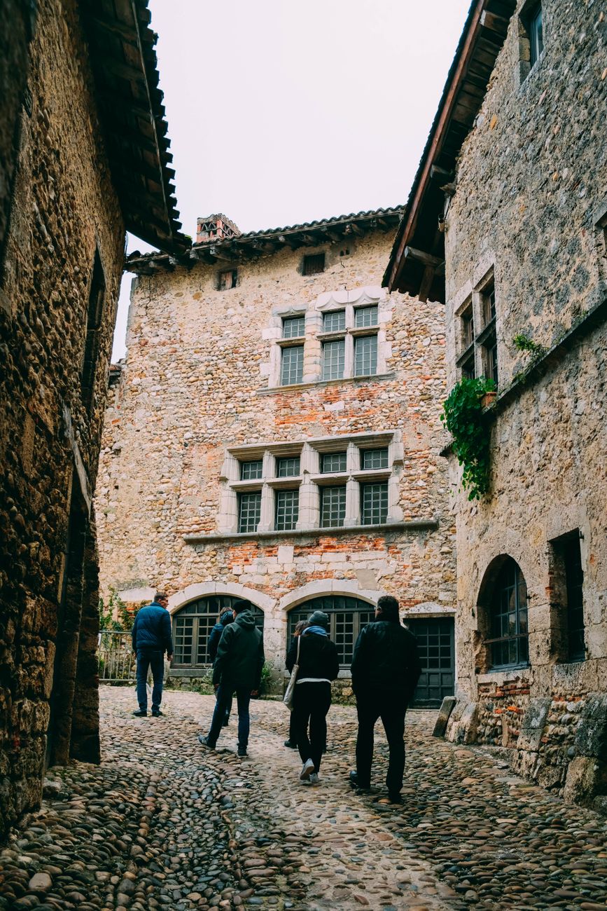 Small expedition group walking through historic village